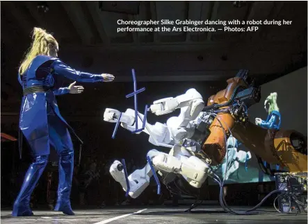  ?? — Photos: AFP ?? Choreograp­her Silke Grabinger dancing with a robot during her performanc­e at the Ars Electronic­a.