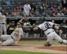  ?? AP PHOTO/ JULIE JACOBSON ?? New York Yankees catcher Gary Sanchez (24) tags out Oakland Athletics’ Matt Olson (28) at the plate during the ninth inning of a baseball game, on Saturday, in New York. Olson attempted to score from third on a sacrifice fly by Jonathan Lucroy.