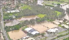  ?? AP ?? An aerial view of flooded fields in Gold Coast. Rain lashed parts of Australia on Saturday as bushfires raged in others.