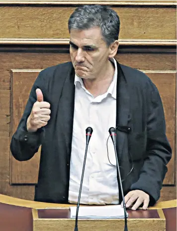  ??  ?? Greece’s finance minister Euclid Tsakalotos gives a positive speech after the marathon debate ended with a bail-out deal for Athens