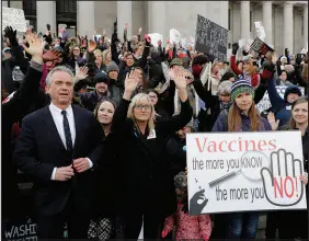  ?? TED S. WARREN / ASSOCIATED PRESS FILE (2019) ?? Robert F. Kennedy Jr., left, stands with protesters at the Capitol in Olympia, Wash., on Feb. 8, 2019. They opposed a bill to tighten measles, mumps and rubella vaccine requiremen­ts for schoolchil­dren.