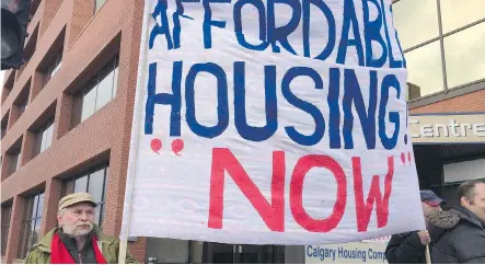  ?? CLARA HO/CALGARY HERALD ?? Protesters gather in front of the Calgary Housing Company office in the 1700 block of Centre Street N.W. to raise awareness about the housing crisis. More than 3,600 names are on the Calgary Housing Company’s growing wait list for affordable housing...
