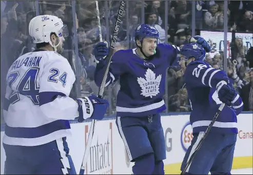  ?? VERONICA HENRI/TORONTO SUN ?? Maple Leafs winger James van Riemsdyk (left) celebrates his game-winning goal in the third period against the Tampa Bay Lightning with teammate Connor Brown as Ryan Callahan looks on at the Air Canada Centre last night.