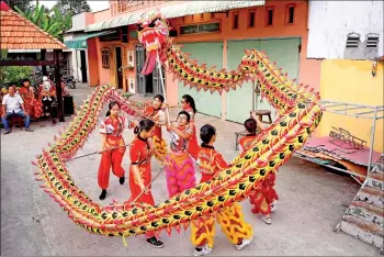  ?? — AFP photos ?? Photo shows Quyen (centre) practising a dragon dance routine along with other female dancers at the Tu Anh Duong lion and dragon dance school in Can Tho city in southern Vietnam’s Mekong Delta.