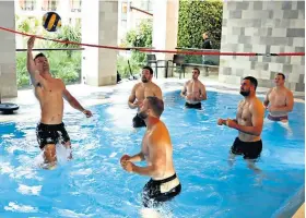  ??  ?? Whole new ball game: England players take to the pool yesterday