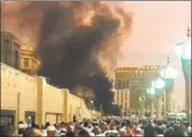  ?? AP ?? People gather after an explosion in Medina, Saudi Arabia, on Monday, near one of Islam's holiest sites in the city.