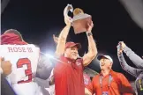  ??  ?? New Mexico State football, led by coach Doug Martin, center, reached a high in 2017 when it won the Arizona Bowl in Tucson over Utah State. Since last December, Martin has had to defend allegation­s of mishandlin­g the program.