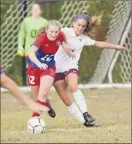  ??  ?? Maple Hill’s Alexis Tedford, left, beats Greenville’s Bella Trostle to the ball on Wednesday.