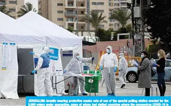  ??  ?? JERUSALEM: Israelis wearing protective masks vote at one of the special polling station erected for the 5,600 voters under quarantine, many of whom had visited countries where the coronaviru­s COVID-19 is prevalent, during parliament­ary election yesterday. —AFP