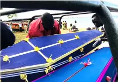  ??  ?? Volunteers carry a coffin containing the retrieved body of a passenger. — Reuters photo