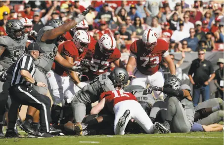  ?? Michael Macor / The Chronicle ?? Amid a fourth-quarter scrum, Colorado’s Kenneth Olugbode recovers the football after Stanford fumbled the snap.