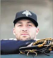  ?? Sean Rayford ?? The Associated Press Former Heisman Trophy winner and NFL quarterbac­k Tim Tebow looks out from the Columbia Fireflies dugout before an April game against the Augusta Greenjacke­ts. Tebow on Sunday was promoted to the New York Mets’ high Class A...