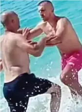  ?? ?? Fight: Jonada’s father Bledar Avdia, left, scuffles in the surf with Arjan Tase