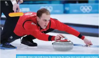  ?? — AFP ?? GANGNEUNG: Britain’s Kyle Smith throws the stone during the curling men’s round robin session between Britain and the US during the Pyeongchan­g 2018 Winter Olympic Games at the Gangneung Curling Centre in Gangneung yesterday.