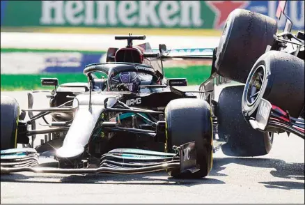 ?? (AP) ?? Mercedes driver Lewis Hamilton of Britain crashes with Red Bull driver Max Verstappen of The Netherland­s during the Italian Formula One Grand Prix, at Monza racetrack, in Monza, Italy, on Sept.12.