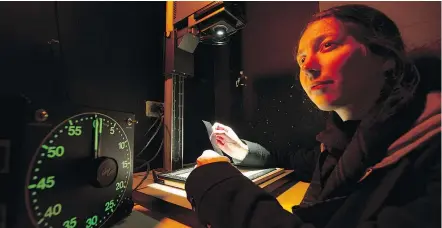  ?? GERRY KAHRMANN/PNG ?? August Bramhoff prepares to print photos from 35-mm film negatives in the Dunbar Community Centre’s darkroom. The soon-to-close darkroom has long been ‘a labour of love’ for Bramhoff.