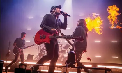  ?? Photograph: Andrew Benge/Redferns ?? Distinct style … Joe Trohman, Patrick Stump and Pete Wentz of Fall Out Boy on stage in Leeds.