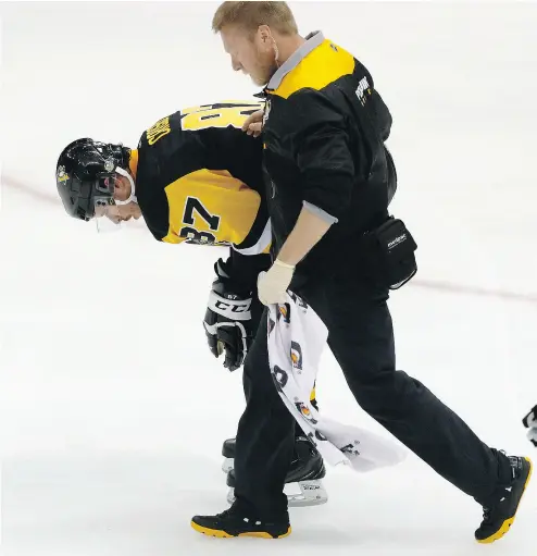  ?? GENE J. PUSKAR / THE ASSOCIATED PRESS ?? After he went headfirst into the boards, the treatment of Penguins captain Sidney Crosby in Game 6 of their series with Washington has raised numerous questions about the NHL’s concussion protocol and how it is implemente­d.