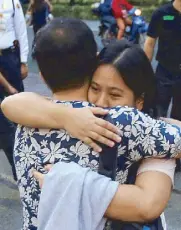  ?? EDD GUMBAN ?? A law graduate gets a hug from a relative prior to taking the Bar exams at the University of Santo Tomas in Manila yesterday.
