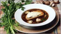  ?? JENNA DEMATTIA MASTERS — STAFF PHOTOGRAPH­ER ?? Julia Child’s recipe for onion soup is augmented by cremini mushrooms and a toasted French bread crouton with goat cheese.