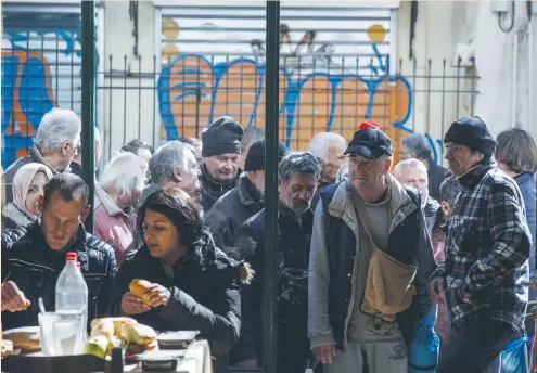  ?? (Alkis Konstantin­idis/Reuters) ?? PEOPLE WAIT in line to enter a soup kitchen run by the Orthodox church in Athens last week. Rescue funds from the European Union and Internatio­nal Monetary Fund saved Greece from bankruptcy. But the austerity and reform policies the lenders attached as...