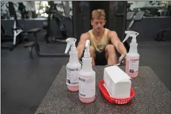  ?? NEWS-SENTINEL PHOTOGRAPH­S BY BEA AHBECK ?? Andrew Davis of Stockton works out near the table with disinfecta­nt sprays at Twin Arbors Private Sports Club in Lodi on Tuesday.