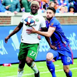  ?? AP ?? Portland Timbers forward Dairon Asprilla (left) and FC Cincinnati defender Mathieu Deplagne vie for the ball in the first half of an MLS match on Sunday, March 17, in Cincinnati.