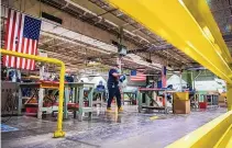  ?? ADAM GLANZMAN/BLOOMBERG ?? Workers assemble face shields at the Cartamundi-owned Hasbro manufactur­ing facility in East Longmeadow, Mass., during 2020.