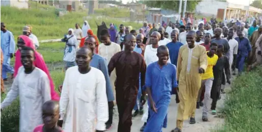  ??  ?? Some of the Gudumbali residents in high spirits during the visit of the army chief