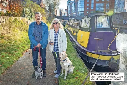  ?? ?? Tracey and Tim Clarke and their two dogs Loki and Ozzie, who all live on a narrowboat