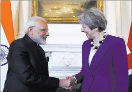  ?? Kirsty Wiggleswor­th ?? The Associated Press Britain Prime Minister Theresa May shakes hands with India Prime Minister Narendra Modi during a bilateral meeting Wednesday in London.