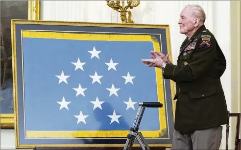  ?? AP 2021 ?? Retired U.S. Army Col. Ralph Puckett applauds during a 2021 Medal of Honor ceremony. President Joe Biden presented the medal to Puckett, citing his efforts at capturing Hill 205 in Korea, when he was grievously wounded during relentless waves of Chinese counteratt­acks.