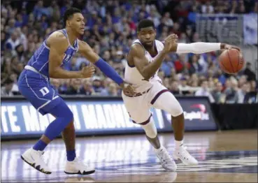  ?? NATI HARNIK — THE ASSOCIATED PRESS ?? Kansas’ Malik Newman dribbles around Duke’s Trevon Duval on March 25 in Omaha, Neb.