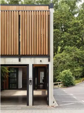  ??  ?? ABOVE Vertical cedar louvres were added to the townhouse’s façade to offset its concrete structure and provide privacy. TOP The 4.5m green wall features a self-irrigation system and includes a mix of native plants that bring texture and a soothing shot of nature to the void beyond the garage.