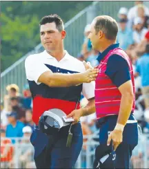  ?? Associated Press photo ?? GaryWoodla­nd, left, is congratula­ted by Sergio Garcia, of Spain, following the first round of the PGA Championsh­ip golf tournament at Bellerive Country Club, Thursday in St. Louis.