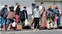  ?? (DM) ?? Migrants deported from the United States are seen outside the air force base upon their arrival in Guatemala City