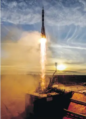  ?? KIRILL KUDRYAVTSE­V / AFP / GETTY IMAGES ?? A Soyuz MS-11 rocket carrying Russian, American and Canadian astronauts takes off from the Baikonur Cosmodrome in Kazakhstan on Monday.