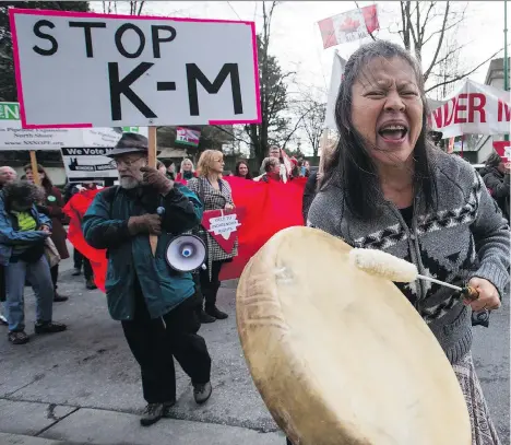  ?? DARRYL DYCK/THE CANADIAN PRESS FILES ?? Patricia Kelly of the Sto:lo First Nation, chants and beats a drum during a protest in January outside National Energy Board hearings in Burnaby on the proposed Trans Mountain oil pipeline expansion. The proposed $5-billion project by Kinder Morgan...