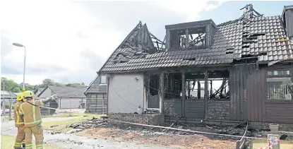  ?? Picture: Gareth Jennings. ?? Firefighte­rs survey the damage to the house at Invergarry Park, St Cyrus.