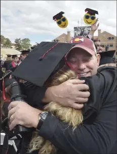  ?? Cliff Grassmick
Staff Photograph­er ?? /
Rachel Silverstei­n, left, hugs her father, Ross Silverstei­n, during the University of Colorado Boulder commenceme­nt on Thursday.