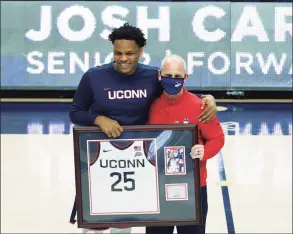  ?? David Butler II / Associated Press ?? UConn’s Josh Carlton, left, with coach Dan Hurley, is recognized during senior day ceremonies on March 6.