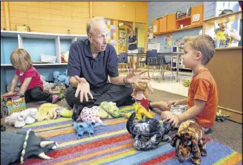  ?? KEITH MYERS / KANSAS CITY STAR ?? Bill Brockman landed a post-retirement job at the Village Church Child and Family Developmen­t Center in Overland Park, Kansas, where his duties include playing with the kids.
