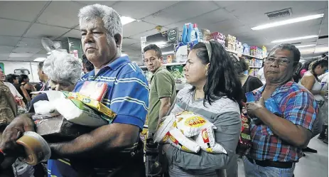  ?? Picture: SCHNEYDER MENDOZA/AFP ?? BETTER TO HOLD BONDS: While Venezuelan­s shopped for groceries across the border at a supermarke­t in Cucuta, Colombia last year because of major food shortages in their own country, investors were profiting mightily from Venezuelan debt