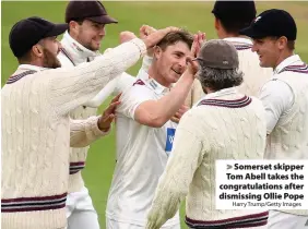  ?? Harry Trump/Getty Images ?? > Somerset skipper Tom Abell takes the congratula­tions after dismissing Ollie Pope