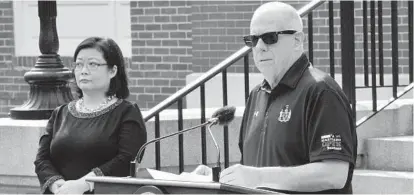  ?? KEVIN RICHARDSON/BALTIMORE SUN ?? Dr. Jinlene Chan, left, acting deputy secretary of the Maryland Department of Health, listens as Gov. Larry Hogan announces Wednesday in Annapolis that masks are no longer required outdoors.