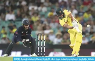  ??  ?? SYDNEY: Australia’s batsman Marcus Stoinis (R) hits a six as England’s wicketkeep­er Jos Buttler (L) looks on, during the third one-day internatio­nal (ODI) cricket match between England and Australia in Sydney yesterday. — AFP