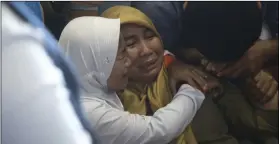  ?? PHOTO/HADI SUTRISNO ?? Relatives of passengers comfort each other as they wait for news on a Lion Air plane that crashed off Java Island at Depati Amir Airport in Pangkal Pinang, Indonesia on Monday. AP