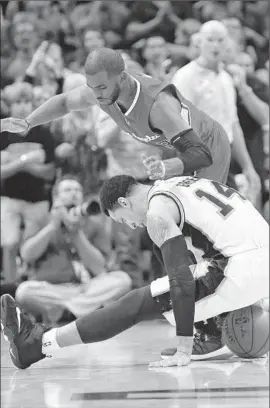  ?? Chris Covatta
Getty Images ?? CLIPPERS’ Chris Paul, top, moves in as San Antonio’s Danny Green loses control of ball in Spurs’ Game 3 blowout, in which Paul had more turnovers than assists.