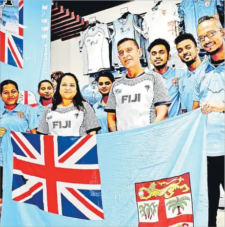  ?? Picture: JONA KONATACI ?? Harrisons Fiji’s Damodar City outlet staff members show their Fiji colours at their shop at Damodar City yesterday.