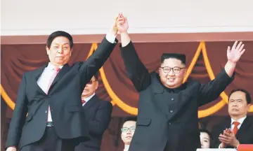  ?? Reuters photo ?? Kim Jong Un and Li Zhanshu wave to people while attending the military parade marking the 70th anniversar­y of North Korea’s foundation in Pyongyang.—